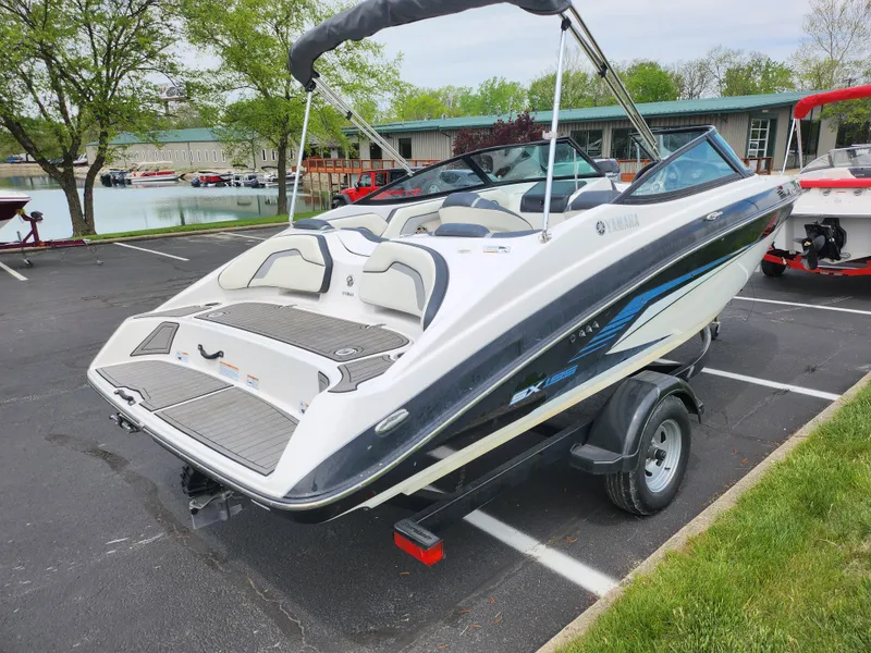 Slide: The Image of 2017 Yamaha Boats SX195 on trailer in parking lot near water. - 1