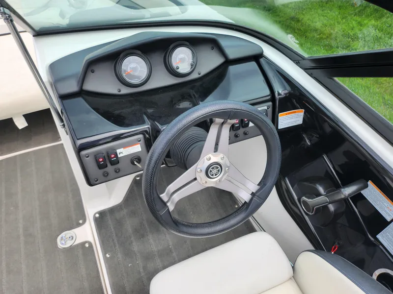 Slide: The Image of 2017 Yamaha Boats SX195 dashboard with steering wheel and control panel. - 13