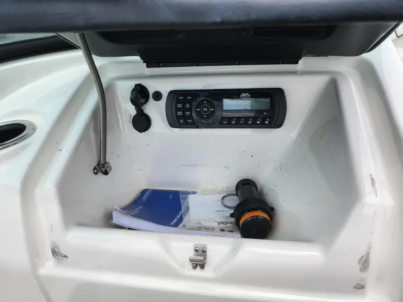 Slide: The Image of 2017 Yamaha SX195 boat dashboard with stereo system and storage compartment. - 15