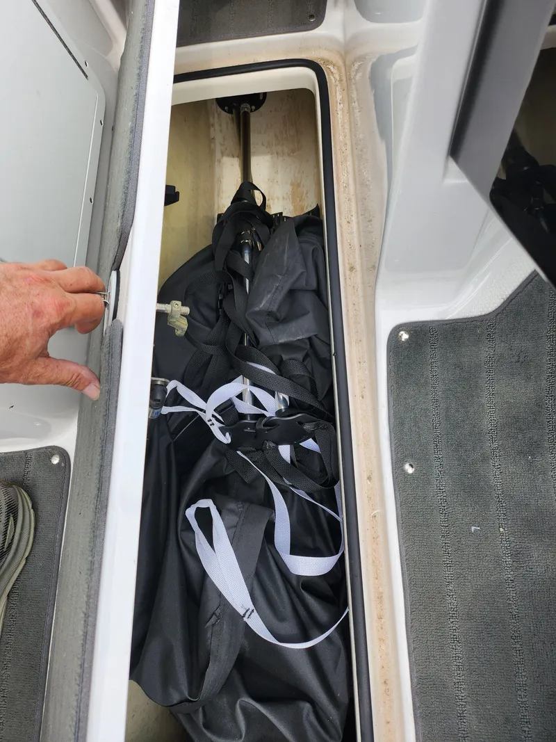 Slide: The Image of 2017 Yamaha SX195 boat storage compartment with gear inside. - 16
