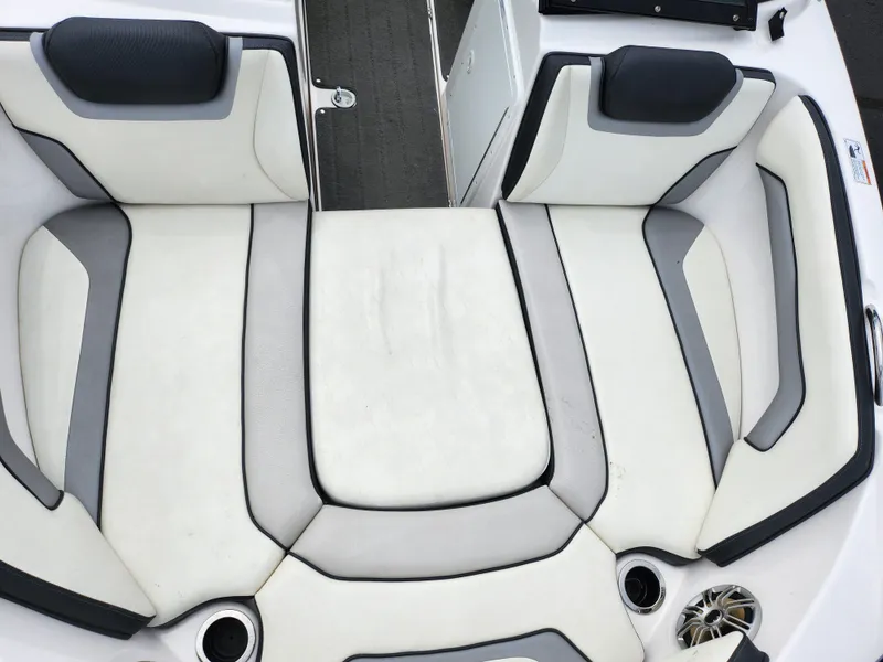 Slide: The Image of 2017 Yamaha Boats SX195 interior seating with white and gray upholstery. - 19