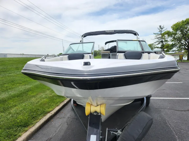 Slide: The Image of 2017 Yamaha Boats SX195 on trailer, parked on asphalt near grass, under cloudy sky. - 6