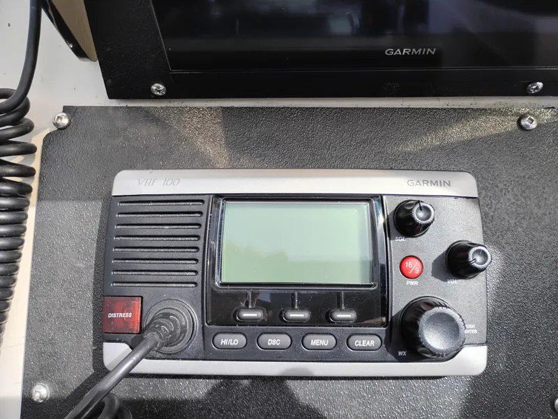 Slide: The Image of Garmin VHF 100 radio on 1989 Boston Whaler 22 Renegade Cabin boat dashboard. - 13