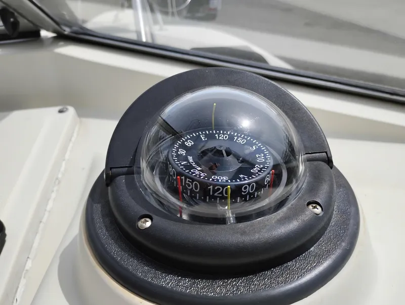 Slide: The Image of Compass on 1989 Boston Whaler 22 Renegade Cabin boat dashboard. - 15