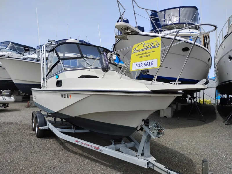 Slide: The Image of 1989 Boston Whaler 22 Renegade Cabin boat for sale on trailer. - 2