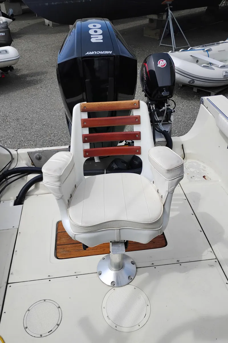Slide: The Image of 1989 Boston Whaler 22 Renegade Cabin boat seat with Mercury outboard motor. - 24