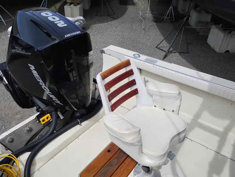 Slide: The Image of 1989 Boston Whaler 22 Renegade Cabin boat with Mercury outboard motor and swivel chair. - 25