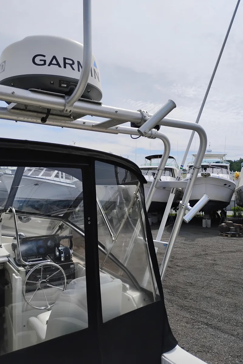 Slide: The Image of 1989 Boston Whaler 22 Renegade Cabin with Garmin radar, docked among other boats. - 27
