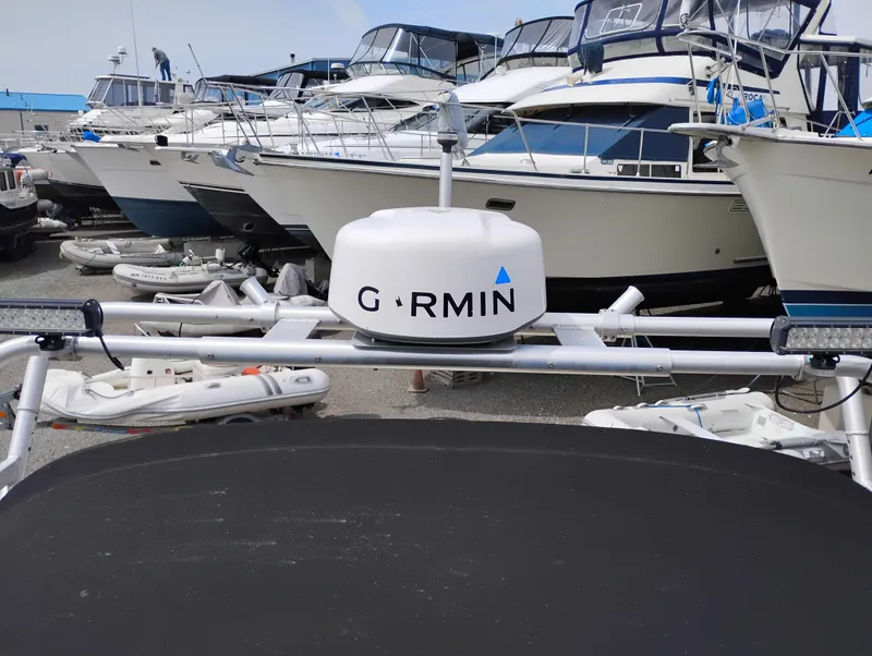 Slide: The Image of 1989 Boston Whaler 22 Renegade Cabin with Garmin radar, docked among other boats. - 30