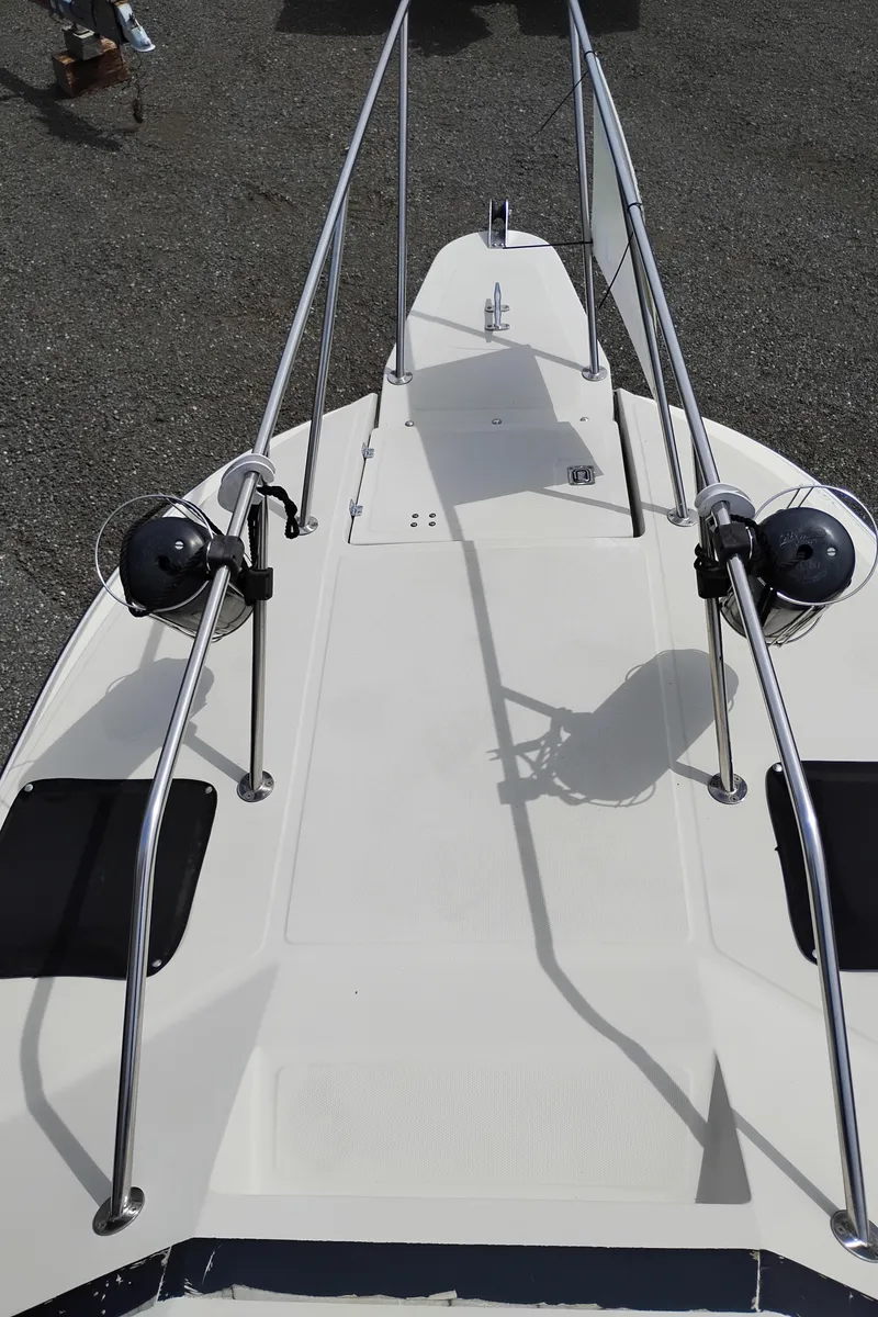 Slide: The Image of 1989 Boston Whaler 22 Renegade Cabin boat deck with railings and equipment. - 34