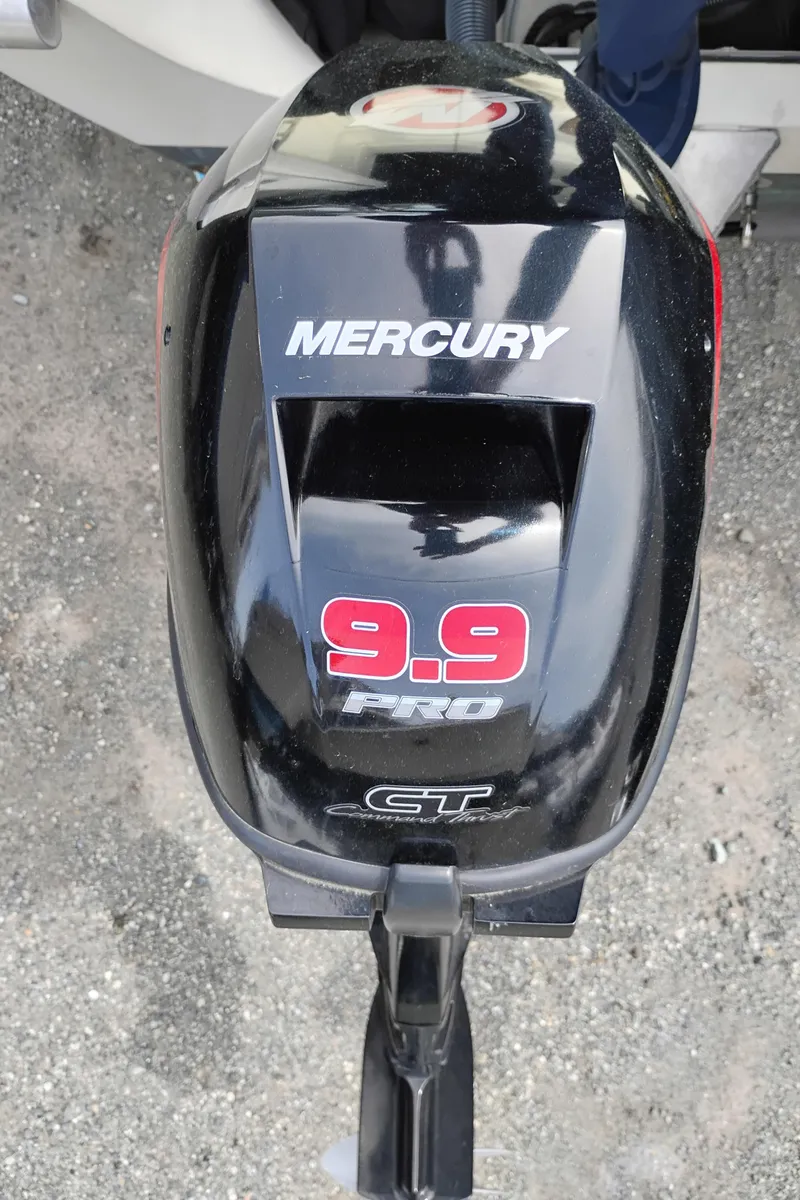 Slide: The Image of Mercury 9.9 Pro outboard motor on 1989 Boston Whaler 22 Renegade Cabin boat. - 9