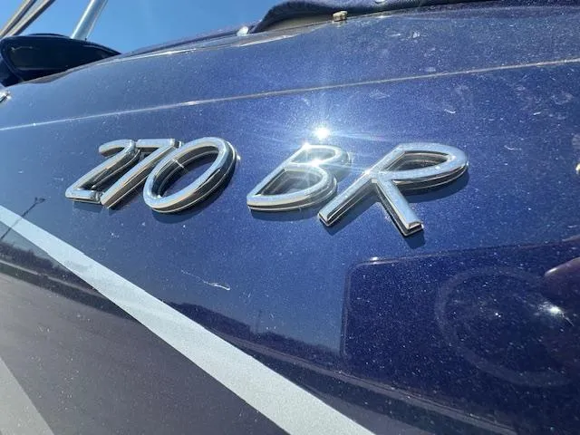 Slide: The Image of 2018 Formula 270 Bowrider boat with "270 BR" emblem on blue hull. - 15