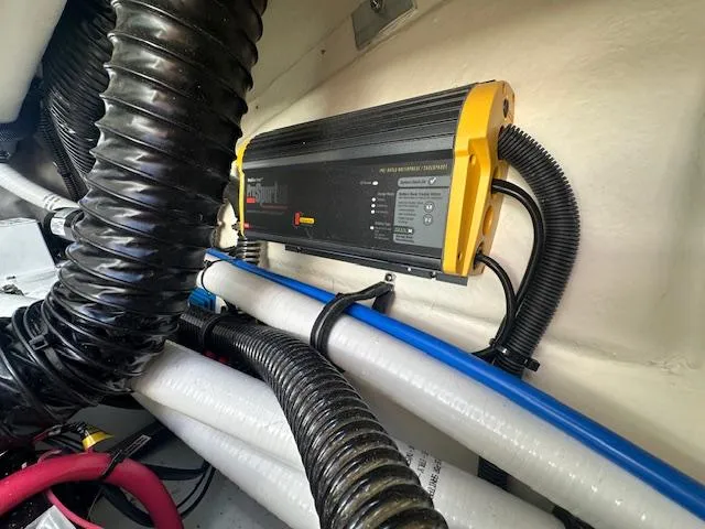 Slide: The Image of 2018 Formula 270 Bowrider engine compartment with battery charger and wiring. - 19