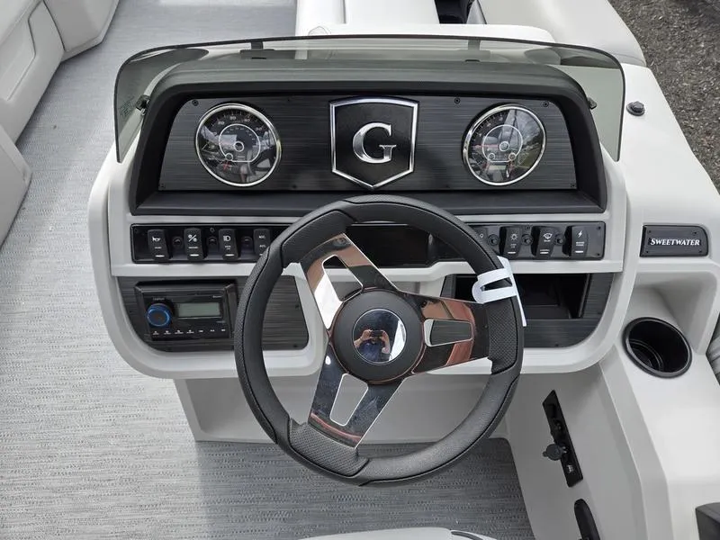 Slide: The Image of Steering console of 2025 Godfrey Sweetwater 2286 FS boat with modern controls and gauges. - 15