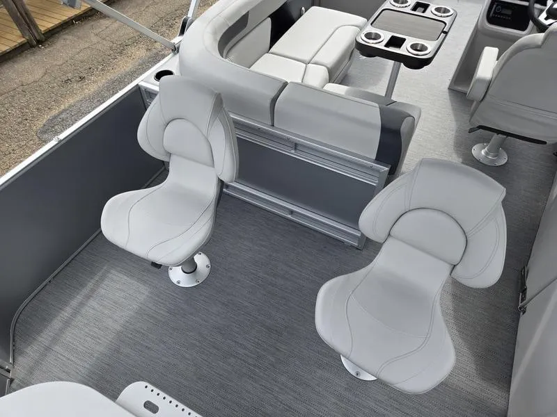Slide: The Image of 2025 Godfrey Sweetwater 2286 FS boat interior with modern seating and table setup. - 19