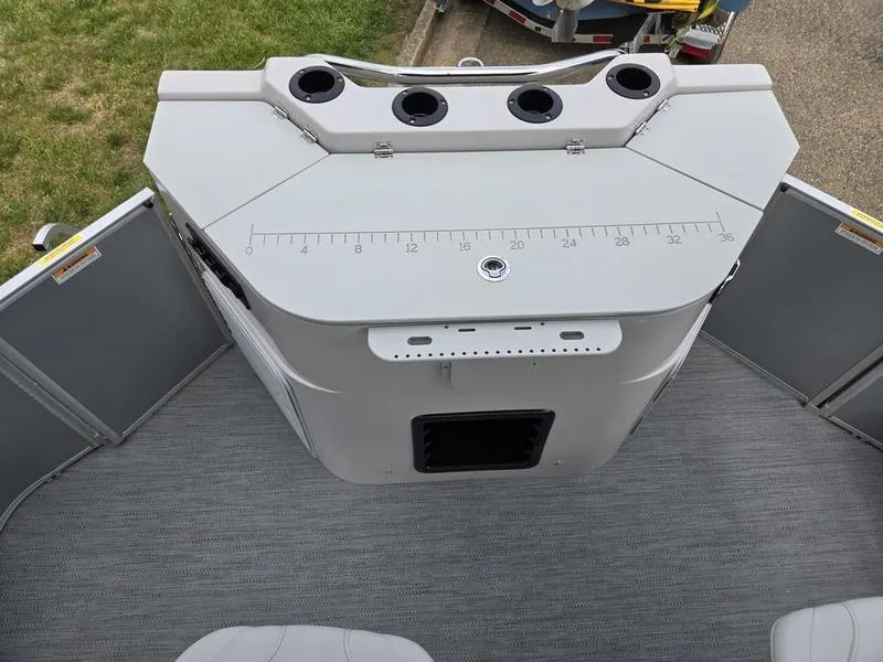 Slide: The Image of Fishing station on 2025 Godfrey Sweetwater 2286 FS pontoon boat, featuring rod holders and measuring ruler. - 20