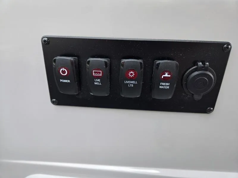 Slide: The Image of Control panel of 2025 Godfrey Sweetwater 2286 FS boat with power and water switches. - 21