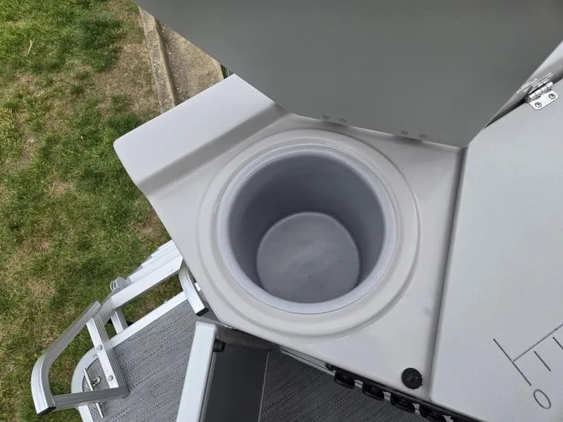 Slide: The Image of Open storage compartment on 2025 Godfrey Sweetwater 2286 FS boat, showing interior details. - 22