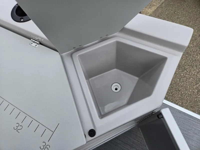 Slide: The Image of Open storage compartment on 2025 Godfrey Sweetwater 2286 FS boat with measurement markings. - 24