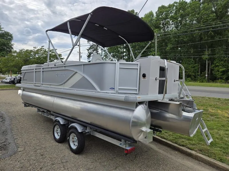 Slide: The Image of 2025 Godfrey Sweetwater 2286 FS pontoon boat on trailer, featuring a canopy and sleek design. - 5