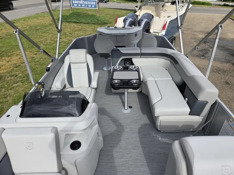 Slide: The Image of 2025 Godfrey Sweetwater 2286 FS boat interior with seating and table, showcasing modern design. - 9