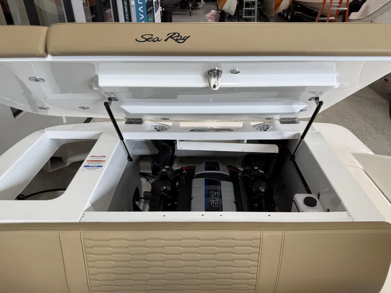Slide: The Image of 2025 Sea Ray SPX230 boat engine compartment with open hatch, showcasing interior mechanics. - 19