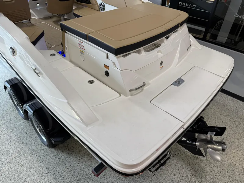 Slide: The Image of 2025 Sea Ray SPX230 boat with sleek white deck and tan seating. - 24