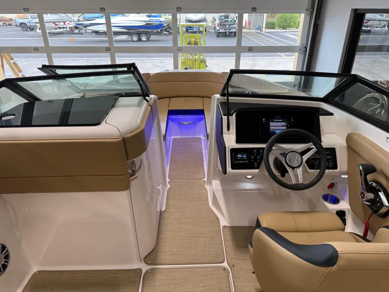 Slide: The Image of 2025 Sea Ray SPX230 boat interior with modern dashboard and seating. - 28
