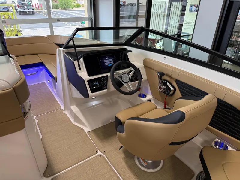 Slide: The Image of Interior of 2025 Sea Ray SPX230 boat with modern helm and tan seating. - 29