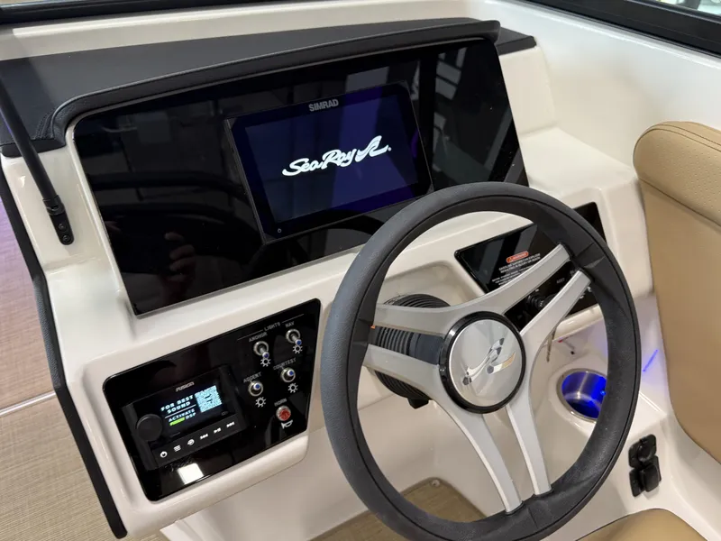 Slide: The Image of 2025 Sea Ray SPX230 dashboard with steering wheel and control panel. - 30