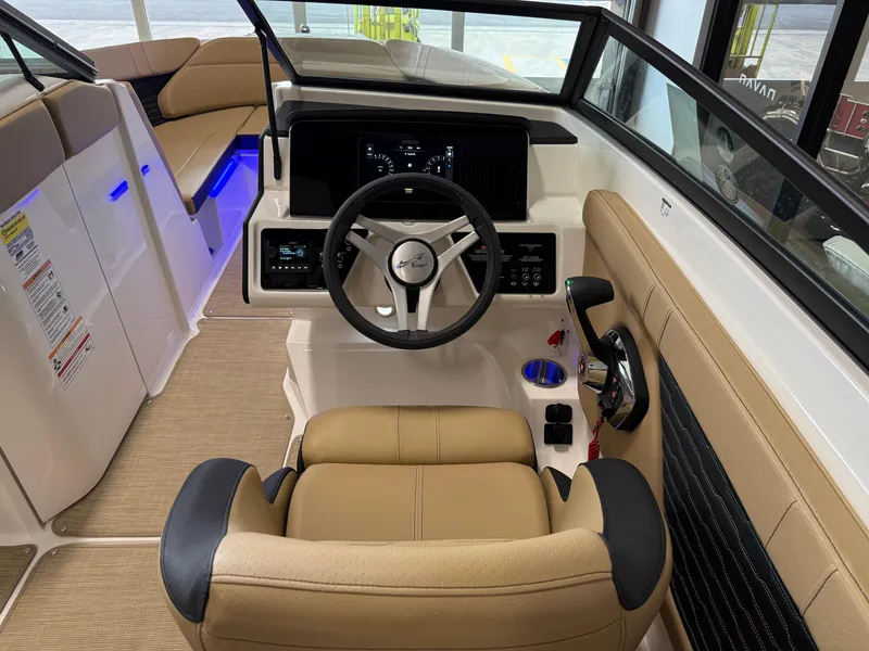 Slide: The Image of 2025 Sea Ray SPX230 boat interior with modern dashboard and tan seating. - 31