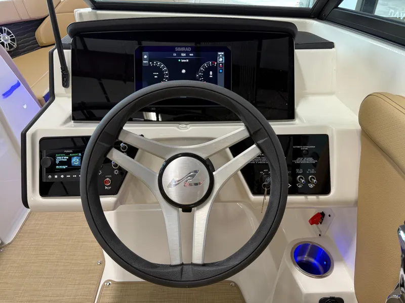 Slide: The Image of 2025 Sea Ray SPX230 boat dashboard with steering wheel and digital display. - 32