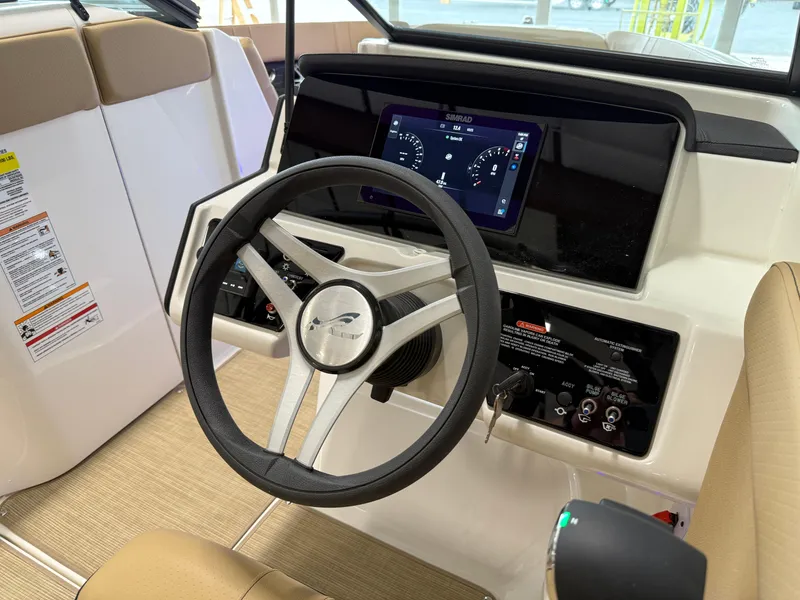 Slide: The Image of 2025 Sea Ray SPX230 boat dashboard with steering wheel and digital display. - 33