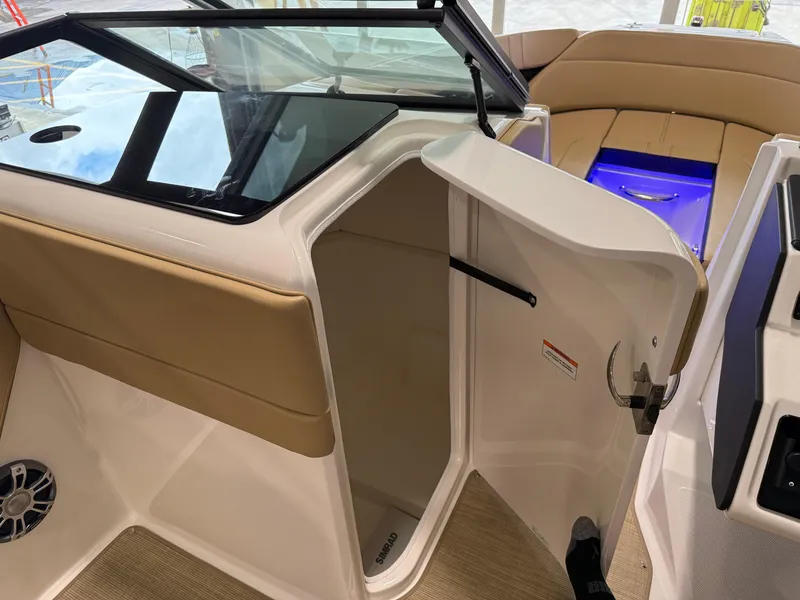 Slide: The Image of 2025 Sea Ray SPX230 boat interior with open storage compartment and seating area. - 36