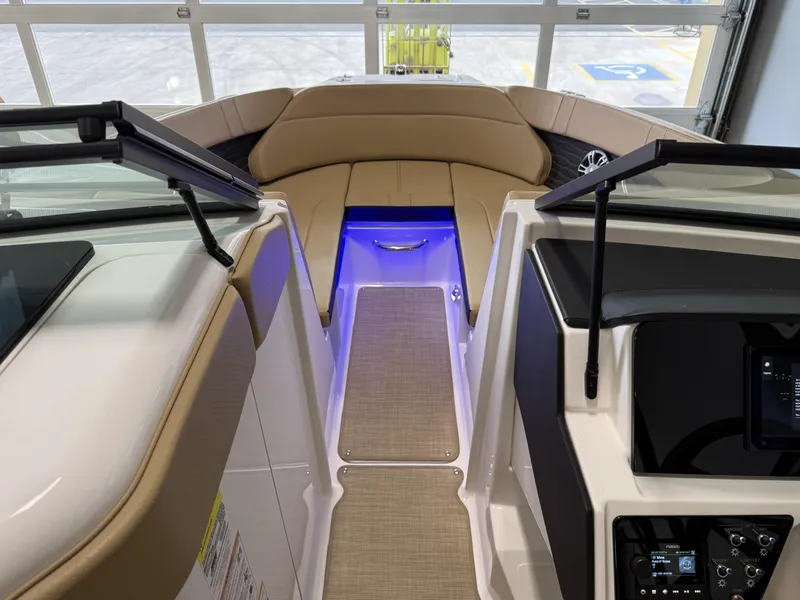 Slide: The Image of 2025 Sea Ray SPX230 boat interior with beige seating and blue LED lighting. - 37