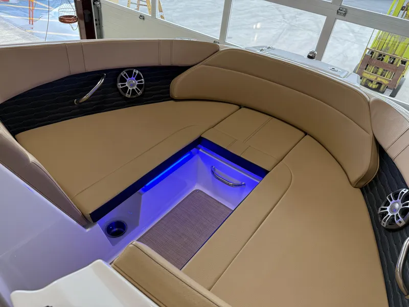 Slide: The Image of Luxurious seating area on 2025 Sea Ray SPX230 boat with ambient blue lighting. - 38
