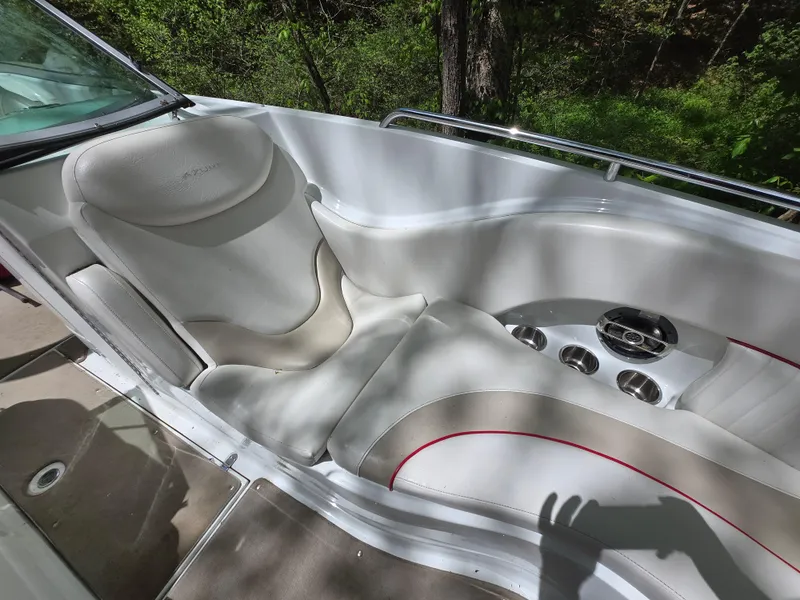 Slide: The Image of Luxurious seating in 2009 Azure AZ298 boat with cup holders, surrounded by greenery. - 12