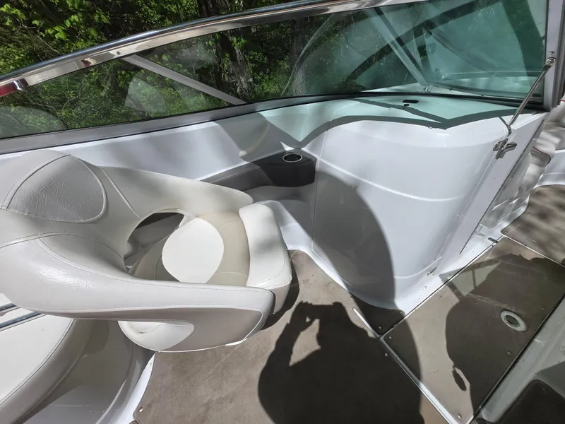 Slide: The Image of Interior of a 2009 Azure AZ298 boat with white seating and glass windshield. - 15