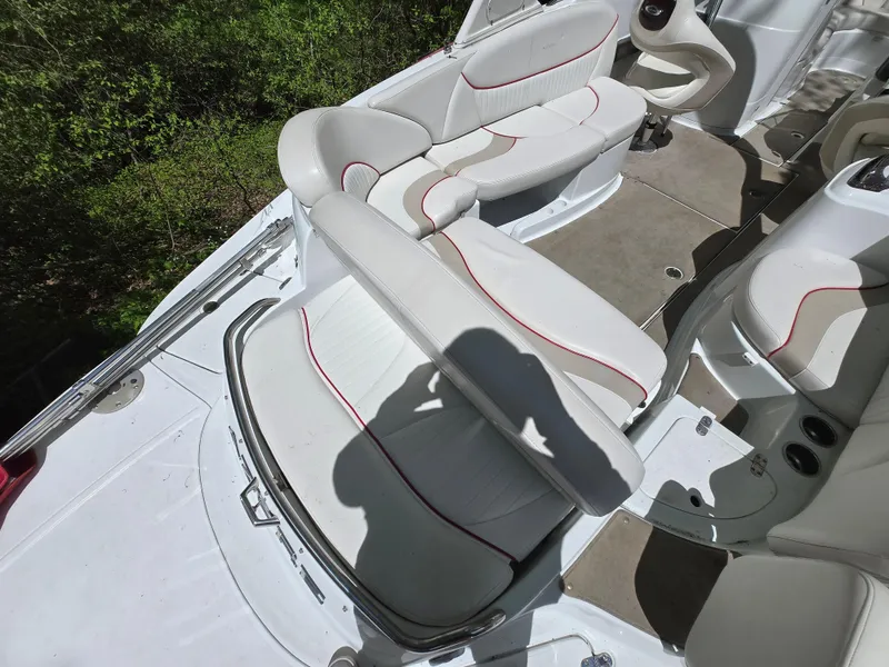 Slide: The Image of 2009 Azure AZ298 boat interior with white and red-trimmed seating, shadow visible. - 18