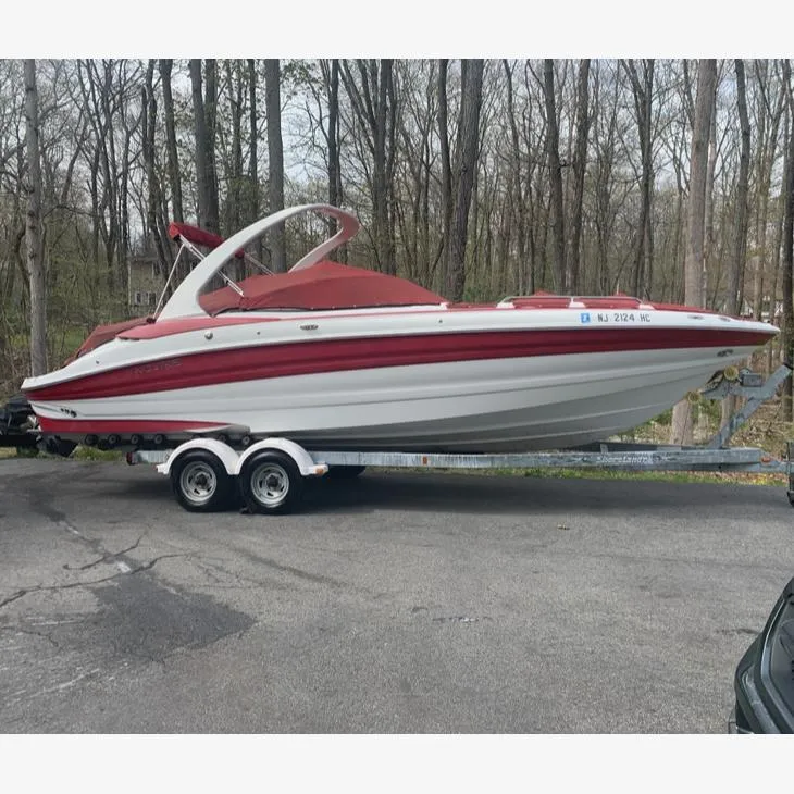 Slide: The Image of 2009 Azure AZ298 boat on trailer in wooded area. - 2