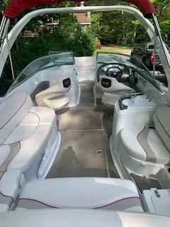 Slide: The Image of 2009 Azure AZ298 boat interior with white seating and red accents, parked outdoors. - 3