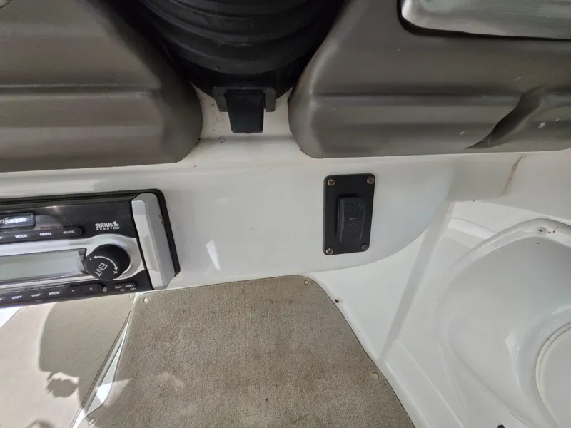 Slide: The Image of Control panel of a 2009 Azure AZ298 boat interior with switches and carpeted flooring. - 30