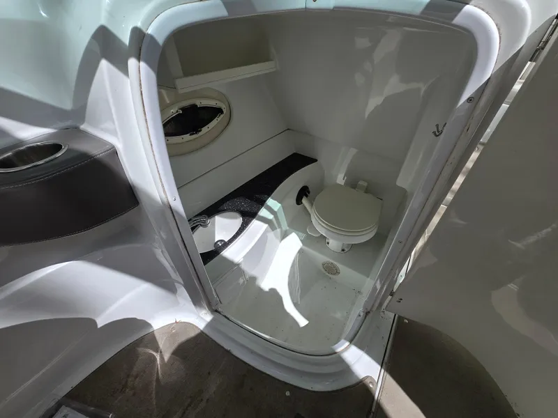 Slide: The Image of Compact boat bathroom in 2009 Azure AZ298 model, featuring a toilet and small window. - 33