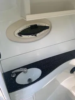 Slide: The Image of 2009 Azure AZ298 boat bathroom with sink, porthole, and sleek countertop design. - 39