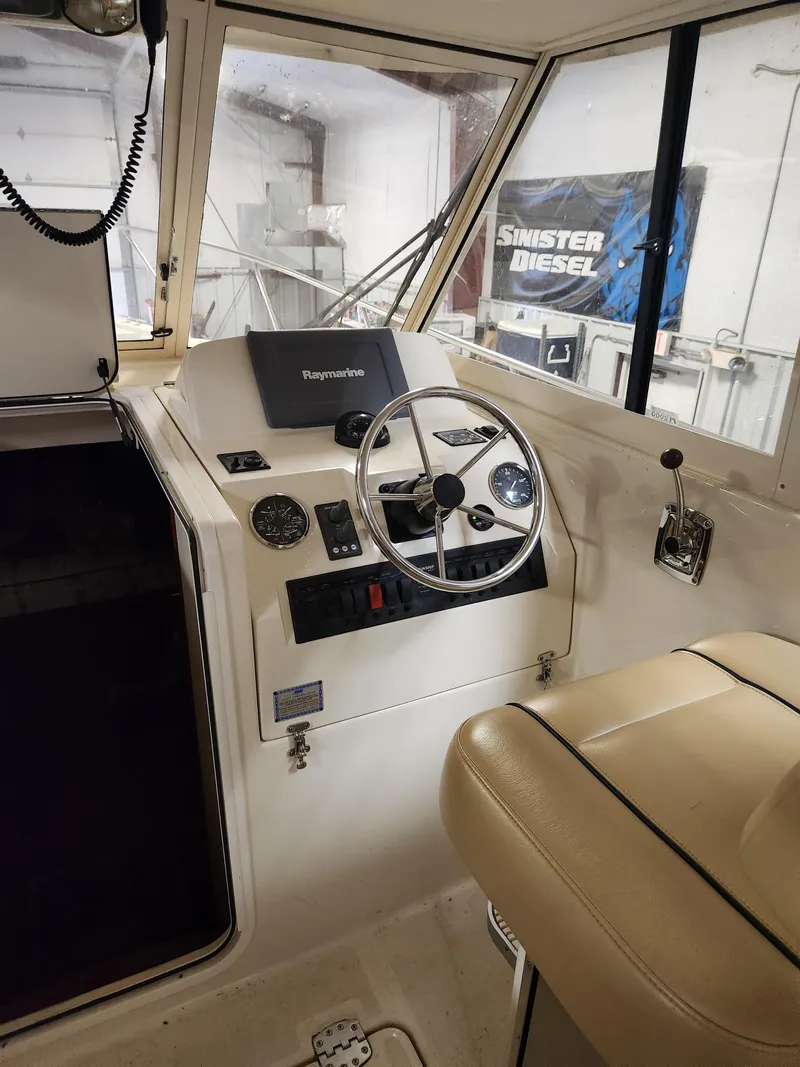 Slide: The Image of 2010 Mainship Pilot 31 boat interior with steering wheel and navigation equipment. - 12