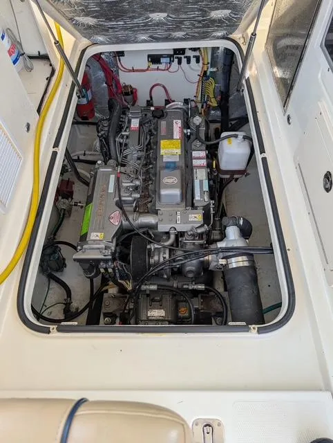 Slide: The Image of 2010 Mainship Pilot 31 engine compartment, showcasing detailed mechanical components and wiring. - 17