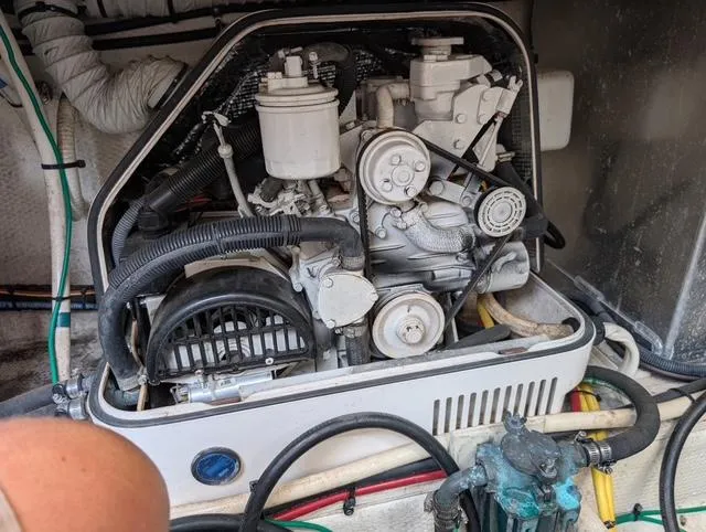 Slide: The Image of Engine compartment of a 2010 Mainship Pilot 31 boat, showcasing mechanical components and hoses. - 23