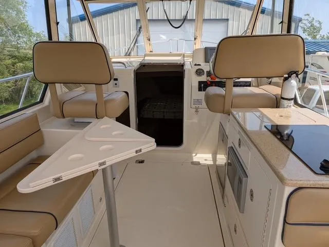 Slide: The Image of Interior of 2010 Mainship Pilot 31 boat with seating, table, and kitchenette. - 27