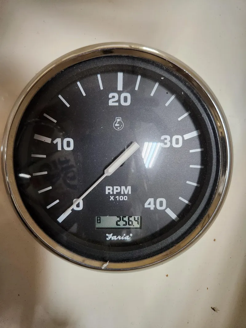 Slide: The Image of Close-up of a 2010 Mainship Pilot 31 RPM gauge displaying 2564 RPM. - 3