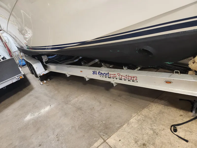 Slide: The Image of 2010 Mainship Pilot 31 boat on trailer in a garage setting. - 4